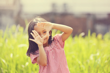 Happy asian girl playing outdoor in sunny day with retro styleの写真素材