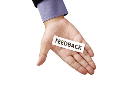 Hand holding paper with feedback text isolated over white の写真素材