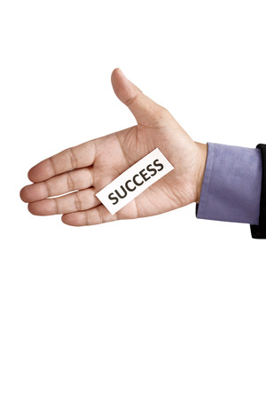 Hand holding paper with success text isolated over white の写真素材
