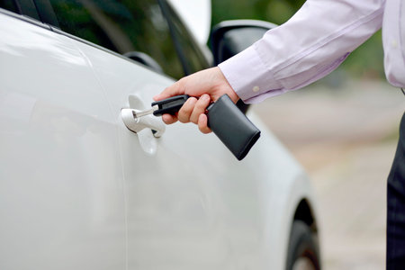Man opening car door using his hand