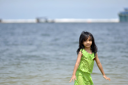 Asian girl playing on the beachの写真素材