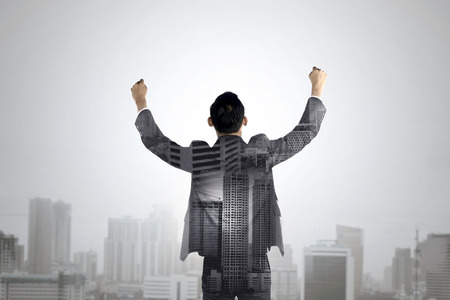 Double exposure of business man raise his hands. Business success conceptual.の写真素材