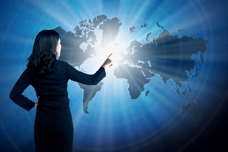 Asian business woman touching world on virtual screen. globalizationbusiness conceptの写真素材