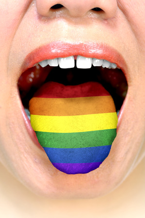 Gay flag on woman tongue. LGBT freedom of speechの写真素材