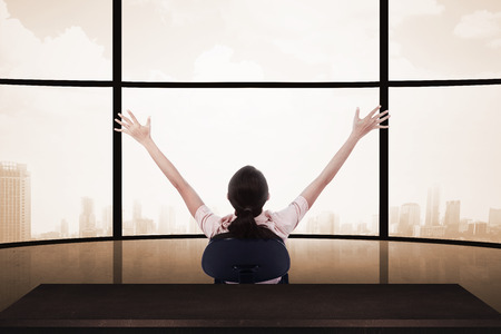 Business woman sitting on the chair with raise hand. Business success conceptの写真素材