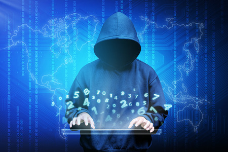 Computer hacker silhouette of hooded man with binary data and network security termsの写真素材