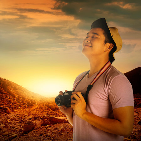 A tourist taking image with camera on mountain landscape