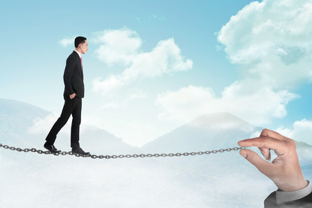 Business person walking on the chain. Business challenge conceptの写真素材