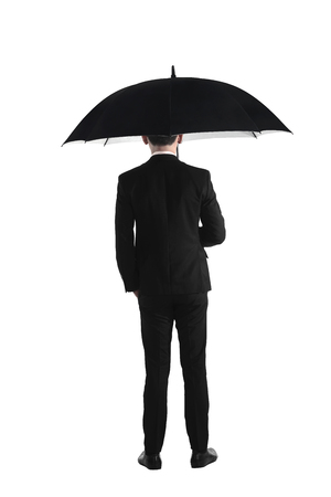 Back view business man standing holding umbrella isolated over white backgroundの写真素材