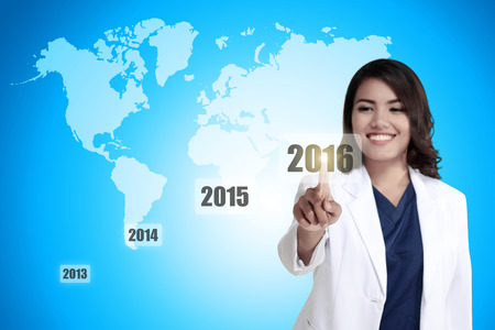 Business person touching 2016 year button on virtual business conceptの写真素材