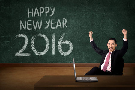 Business man in front of happy new year 2016 writing. New year conceptの写真素材
