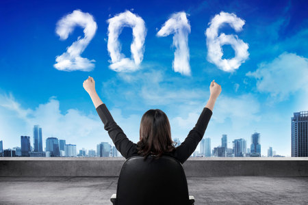 Business person sit on chair looking 2016 cloud shape number. New year concept