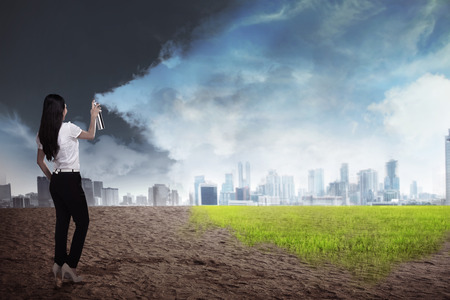 Asian business person spraying bottle of aerosol to fix the futureの写真素材