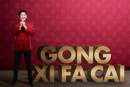 Gong Xi Fa Cai writing and chinese man smiling. Happy chinese new year concept