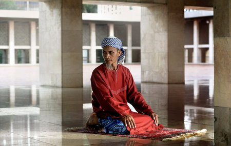 Religious muslim man praying inside the mosque