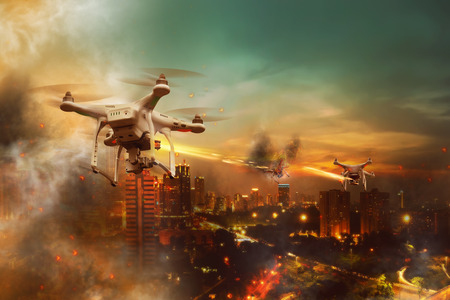 Drones battle over the city at night timeの写真素材