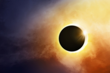 Total solar eclipse over the dark skyの写真素材