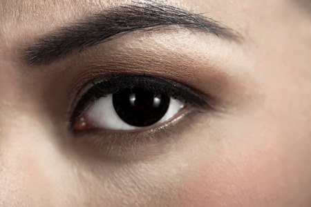 Image of asian woman's eye looking into the cameraの写真素材