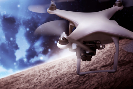 White small drone flying on the outer spaceの写真素材