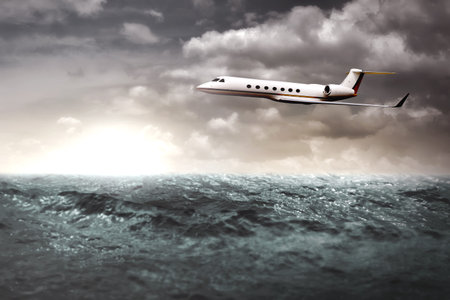 Private jet flying over the ocean. Business trip conceptの写真素材