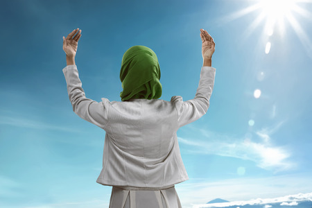 Back view of muslim woman praying wearing hijabの写真素材