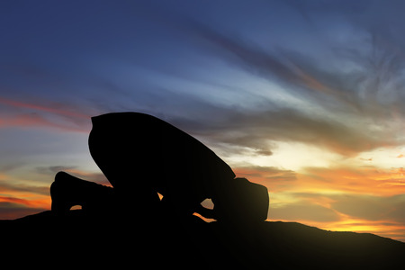 Image of silhouette man praying with sunset backgroundの写真素材