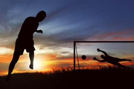 Silhouette of soccer player ready to execute penalty kick on the fieldの写真素材