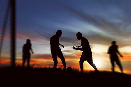 Silhouette of soccer player ready kick ball on the fieldの写真素材
