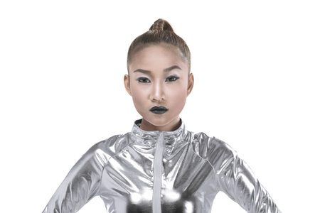 Asian woman wearing silver latex suit isolated over white background. Futuristic concept imageの写真素材