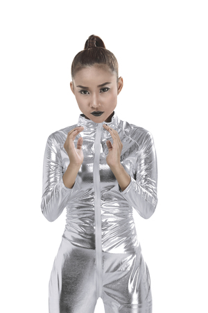 Asian woman wearing silver latex suit isolated over white background. Futuristic concept imageの写真素材