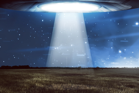 UFO flying in a dark sky. Alien conceptの写真素材