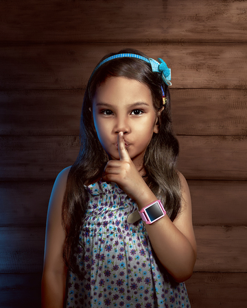 Little girl wearing smartwatch on her arm.の写真素材