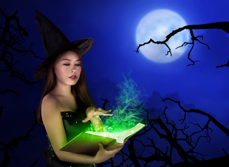 Young asian witch woman with hat standing at night with full moon