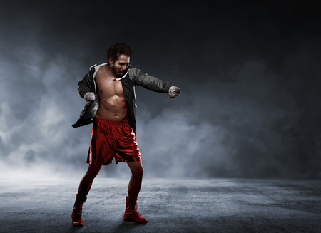 Action asian man in sportswear using strap in wrist making punch on the gymの写真素材