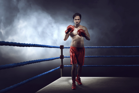 Professional asian boxer guy with glove was practicing on ring boxing arenaの写真素材