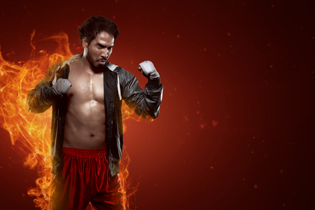 Portrait of muscular asian male boxer in dramatic lightの写真素材