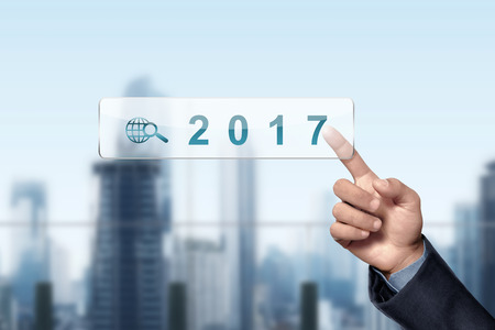 Asian businessman hand touched 2017 on virtual screenの写真素材