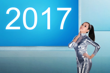 Pretty asian woman wearing latex jumpsuit. Inside cyber world. 2017 new year conceptの写真素材