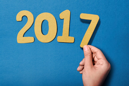 Human hand holding 2017 number. New year concept