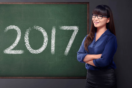 Asian business woman with 2017 number on the board. Business vision concept