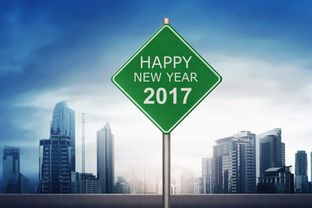 Road sign with number 2017 over blue sky background. Happy new year concept
