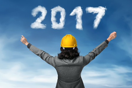 Business person looking 2017 cloud shape number. New year conceptの写真素材