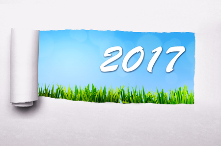 Paper tearing with 2017 number background. Happy new year conceptの写真素材
