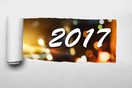 Paper tearing with 2017 number background. Happy new year conceptの写真素材