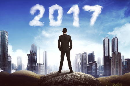 Back view business man looking 2017 cloud on the sky. New year conceptの写真素材