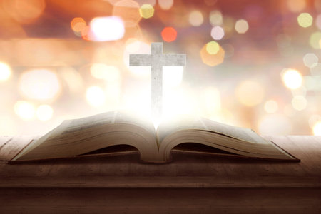 Open holy bible with wooden cross in the middle. Christian conceptの写真素材