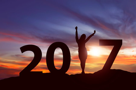 Silhouette young woman on the hill. 2017 new year concept