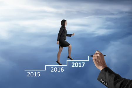 Image of business woman walking on drawing stairs. Career in new year conceptの写真素材