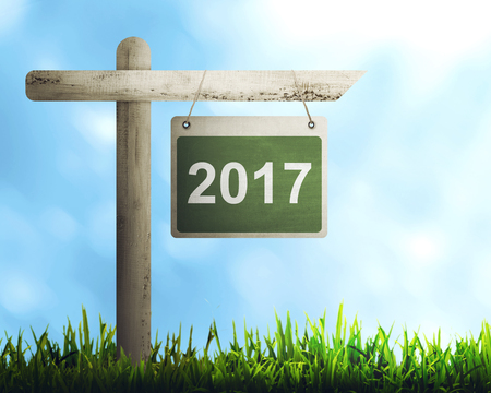Road sign with number 2017 over blue sky background. Happy new year conceptの写真素材
