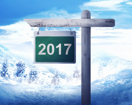 Road sign with number 2017 over blue sky background. Happy new year conceptの写真素材